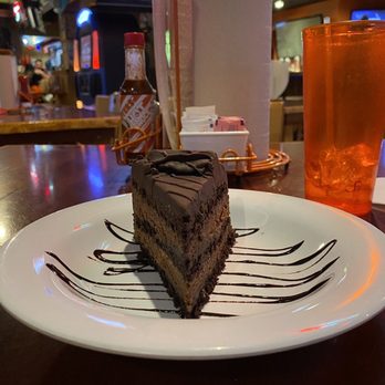 Hooters - a piece of chocolate cake on a plate - American Near Me - Wethersfield, Connecticut Hooters - a piece of chocolate cake on a plate - American Near Me - Wethersfield, Connecticut