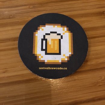 Revival Brewery + Arcade - a mug of beer on a coaster - Arcades Near Me - Calgary, Alberta