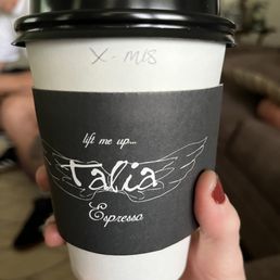 a hand holding a coffee cup