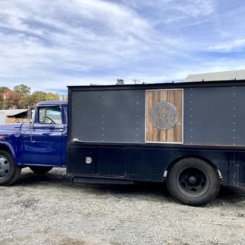 Iron & Grain Co - a blue truck parked in a lot - Food Trucks Near Me