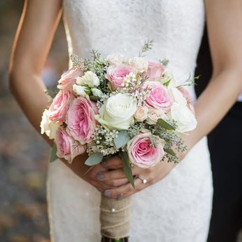QFC - a bride holding a bouquet of pink and white roses - Grocery Near Me - Seattle, Washington
