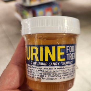 IT'SUGAR - a hand holding a jar of urine - Candy Stores Near Me - Las Vegas, Nevada