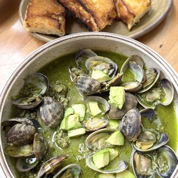 Chaak Kitchen - Manila clams with sausage and garlic bread to compliment the flavorful green broth. - Cocktail Bars Near Me - Tustin, California Chaak Kitchen - Manila clams with sausage and garlic bread to compliment the flavorful green broth. - Cocktail Bars Near Me - Tustin, California
