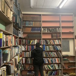 Zubal Books - my friend next to an amazing selection of books, i found a biography of Jung on the bottom left of the shelf my friend is facing