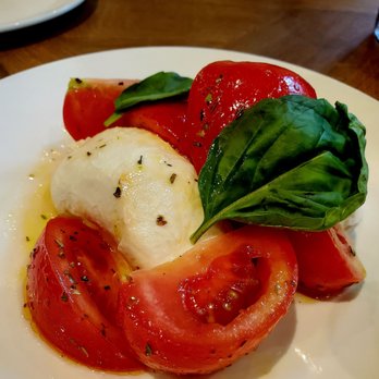 Eataly Boston - Sad "heirloom tomatoes " on our caprese salad. I tuned the color up on this photo. - Pizza Near Me - Boston, Massachusetts