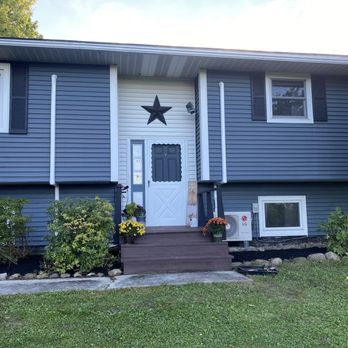Rycoe Enterprises - the front of a house with a star on the front door - Landscaping Near Me - Auburn, New York