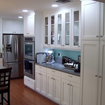 Cabinet Experts - a kitchen with white cabinets and stainless steel appliances - General Contractors Near Me - El Cajon, California