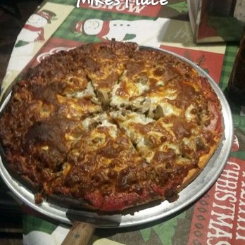 Mikes Place - a pizza on a table - Pizza Near Me