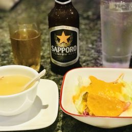 A Sapporo Authentic Japanese Beer with A Frosted Glass, Chicken Noodle Soup, & A Ginger Dressing Salad to Start it Off. A Sapporo Authentic Japanese Beer with A Frosted Glass, Chicken Noodle Soup, & A Ginger Dressing Salad to Start it Off.