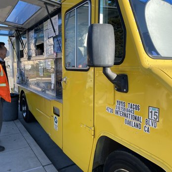 Yuyis Tacos - a man standing in front of a food truck - Food Trucks Near Me Yuyis Tacos - a man standing in front of a food truck - Food Trucks Near Me
