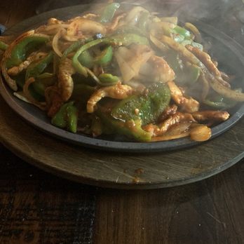 Zapata Tacos and Tequila Bar - Sizzling Chicken Fajitas,with peppers and onions , refried beans and rice on the side - Mexican Near Me - Norcross, Georgia
