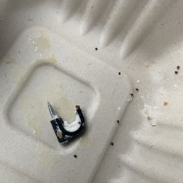 a broken cigarette in a styrofoam container