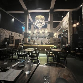 Mantra by Host - an empty restaurant with a chandelier hanging from the ceiling - Indian Near Me - Toronto, Ontario