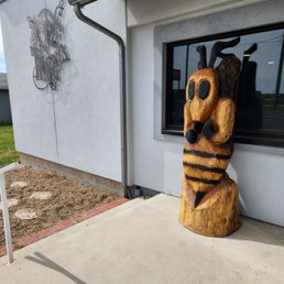 a wooden statue of a bee a wooden statue of a bee