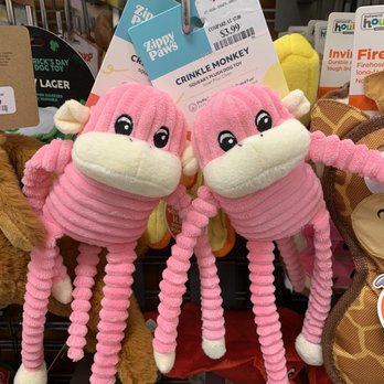 TJ Maxx - Zippy Paws pink Crinkle Monkeys. - Pair of pink Crinkle Monkey plush toys with long, coiled limbs hanging on a display hook in a pet store. - Department Stores Near Me - Concord, California