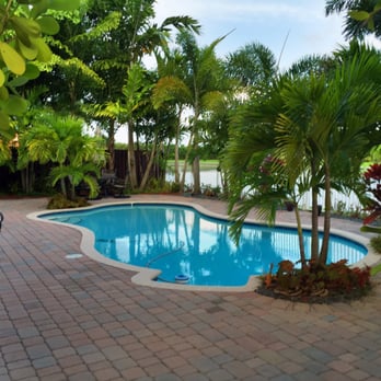 Anderson Landscaping - a pool surrounded by palm trees - Landscaping Near Me - Homestead, Florida