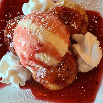The Bit O'Denmark - Solvang traditional, pretty much donut holes cover of raspberry sauce, powder sugar and topped with vanilla cream - Scandinavian Near Me - Solvang, California The Bit O'Denmark - Solvang traditional, pretty much donut holes cover of raspberry sauce, powder sugar and topped with vanilla cream - Scandinavian Near Me - Solvang, California