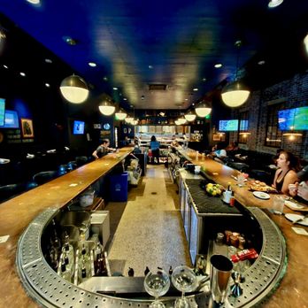 The General Public - a bar with people sitting at tables - New American Near Me - Houston, Texas The General Public - a bar with people sitting at tables - New American Near Me - Houston, Texas