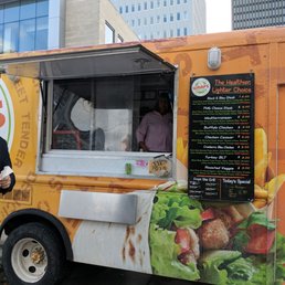 a man standing in front of a food truck