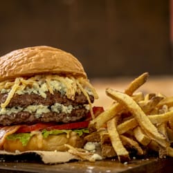 MOOYAH Double Burger with blue cheese, bacon, and fried onion strings.