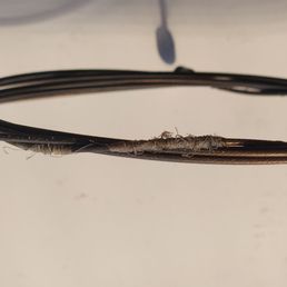 My badly frayed rear derailleur cable. It jammed solid and no shifting was possible.