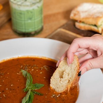 Little Finch - Person dipping a piece of bread in tomato soup - Bakeries Near Me - Denver, Colorado Little Finch - Person dipping a piece of bread in tomato soup - Bakeries Near Me - Denver, Colorado