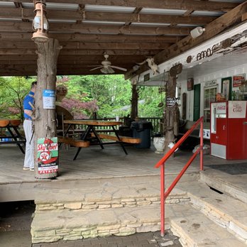Amos's BBQ - Covered outside area and entrance to Amos Barbecue with 2 large dining tables. - Barbeque Near Me - Ball Ground, Georgia Amos's BBQ - Covered outside area and entrance to Amos Barbecue with 2 large dining tables. - Barbeque Near Me - Ball Ground, Georgia