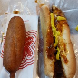 Corn dog and chili dog with mustard Corn dog and chili dog with mustard