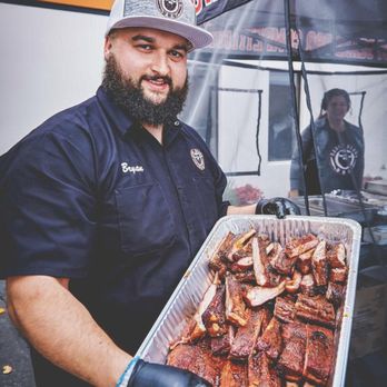 Saucy Beard Bbq - Bryan of Saucybeardbbq showing the ribs. - Caterers Near Me