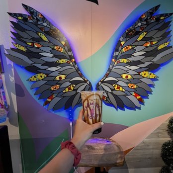 Teamont Boba - a hand holding a coffee cup with wings painted on it - Bubble Tea Near Me - Clermont, Florida Teamont Boba - a hand holding a coffee cup with wings painted on it - Bubble Tea Near Me - Clermont, Florida