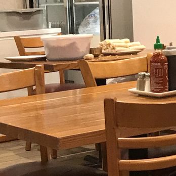 Pho 24 - Table with prepared uncooked egg rolls left unattended in dining room. - Vietnamese Near Me - Annandale, Virginia