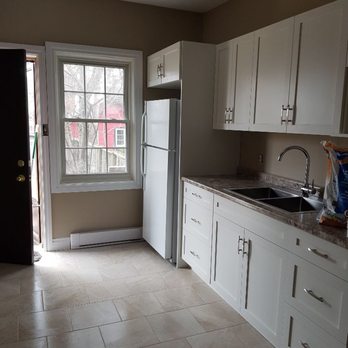 Interior Renovations - a kitchen with white cabinets and tile floor - General Contractors Near Me - Windsor, Ontario Interior Renovations - a kitchen with white cabinets and tile floor - General Contractors Near Me - Windsor, Ontario