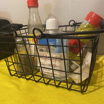 Mr. Spud’s - a black wire basket with bottles of condiments - Southern Near Me - Fairhope, Alabama Mr. Spud’s - a black wire basket with bottles of condiments - Southern Near Me - Fairhope, Alabama