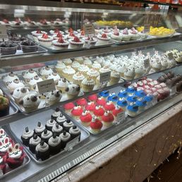 Dessert display case. Variety of cupcakes.