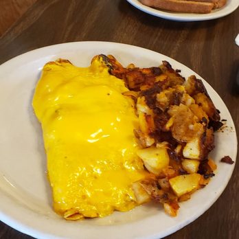 The Egg Connection - Ham and cheese omelet. Potatoes a bit too burnt. The outside  of this omelet looked good but inside the whites were uncooked. Wierd. - Breakfast & Brunch Near Me - Tucson, Arizona