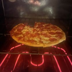 Pizza Hut - Pizza actually being cooked. After another 6 mins at 425 degrees it was finally edible.
