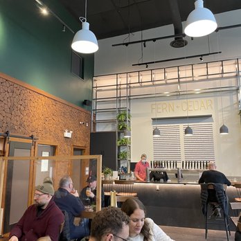 Fern and Cedar Brewing - Interior - beautiful forest green with woodsy walls - Breweries Near Me - Qualicum Beach, British Columbia