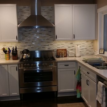 Gianni Durigon - a kitchen with stainless steel appliances - Flooring Near Me Gianni Durigon - a kitchen with stainless steel appliances - Flooring Near Me
