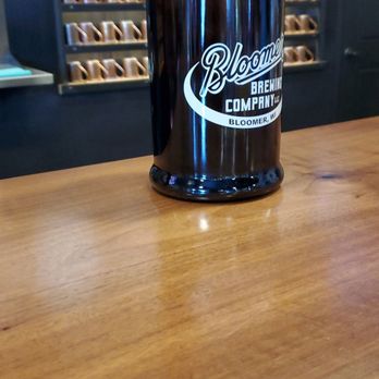 Bloomer Brewing - a growl of beer on a wooden table - Bars Near Me - Bloomer, Wisconsin
