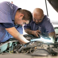 UEI College - Gardena - Automotive Technician students working in the lab.