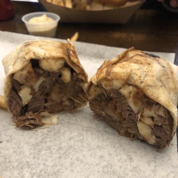 Block 16 - Poutine Burrito. Loaded with beef, cheese curds, potatoes, and smothered in savory gravy - American Near Me - Omaha, Nebraska