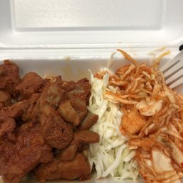 Korean chicken with kimchi and coleslaw. You get two sides with your main on a bed of rice.