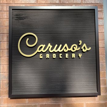 Caruso's Grocery - a sign on a brick wall - Italian Near Me - Washington, DC, District of Columbia