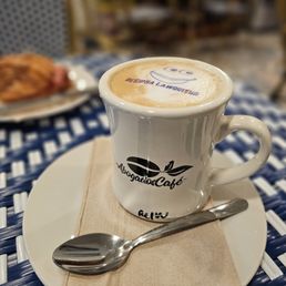 a cup of cappuccino and a spoon