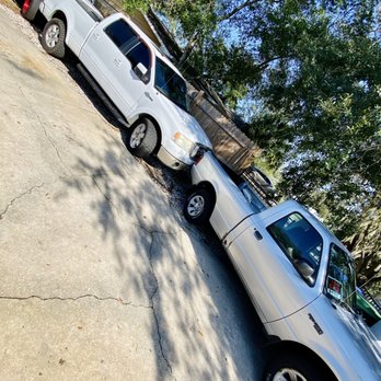 Super Scapes - two trucks parked in a driveway - Tree Services Near Me - Casselberry, Florida