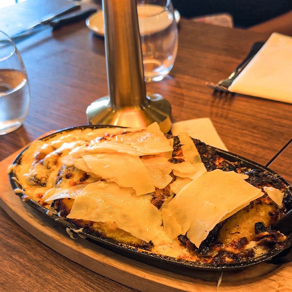 Emiliano’s Steakhouse - Gratin & Glory: Sweet plantains with white cheese cream and parmigiano-reggiano - Steakhouses Near Me - Antioch, Tennessee Emiliano’s Steakhouse - Gratin & Glory: Sweet plantains with white cheese cream and parmigiano-reggiano - Steakhouses Near Me - Antioch, Tennessee