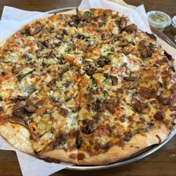 Dimond Slice Pizza - Vegetarian pizza with tomatoes. Spinach, red onion, peppers, artichoke and mushrooms.