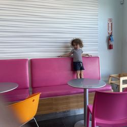 TCBY Philips Plaza - Parent just sat there watching her child run back and forth in her nasty germ-ridden shoes where other people have to sit.