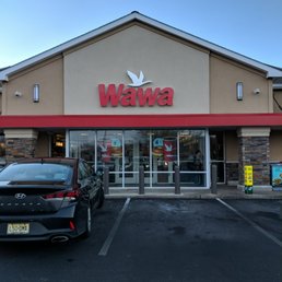 a car parked in front of a wawa restaurant a car parked in front of a wawa restaurant