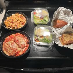 Rincon Italiano - Take out order.  Chicken Parm, chicken penny pasta with vodka sauce, side, salads, and garlic bread.